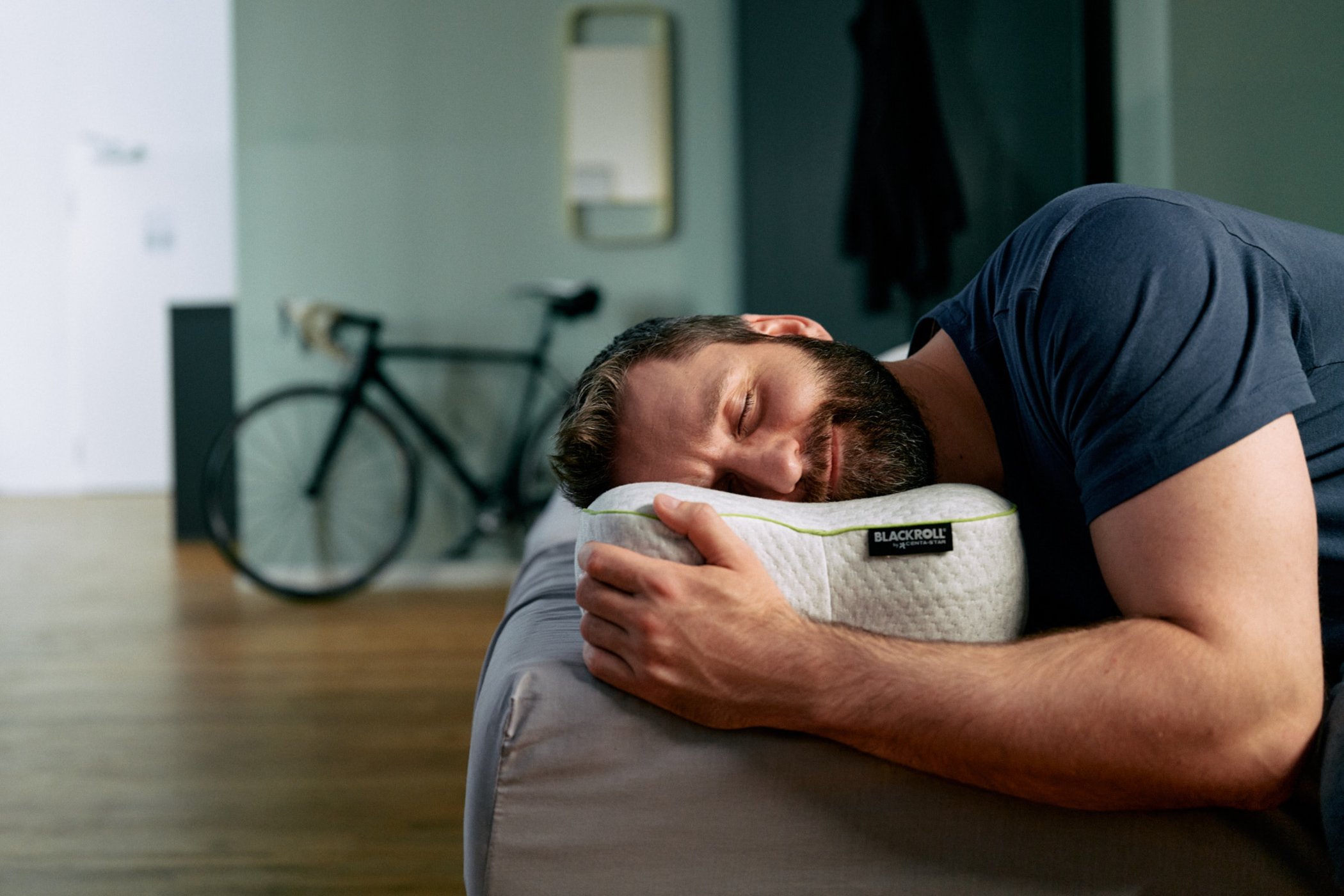 A person sleeping on the BLACKROLL Pillow