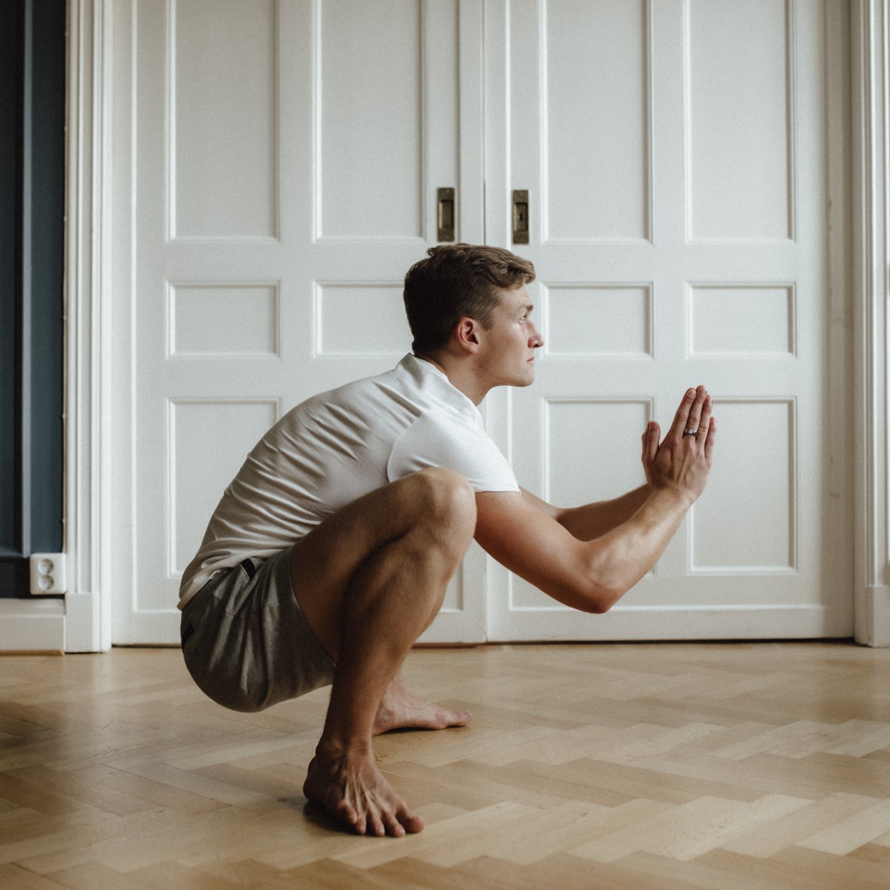 Deep squat (sitting on heels); the superficial back line is stretched. Lift the sternum and lengthen the spine.