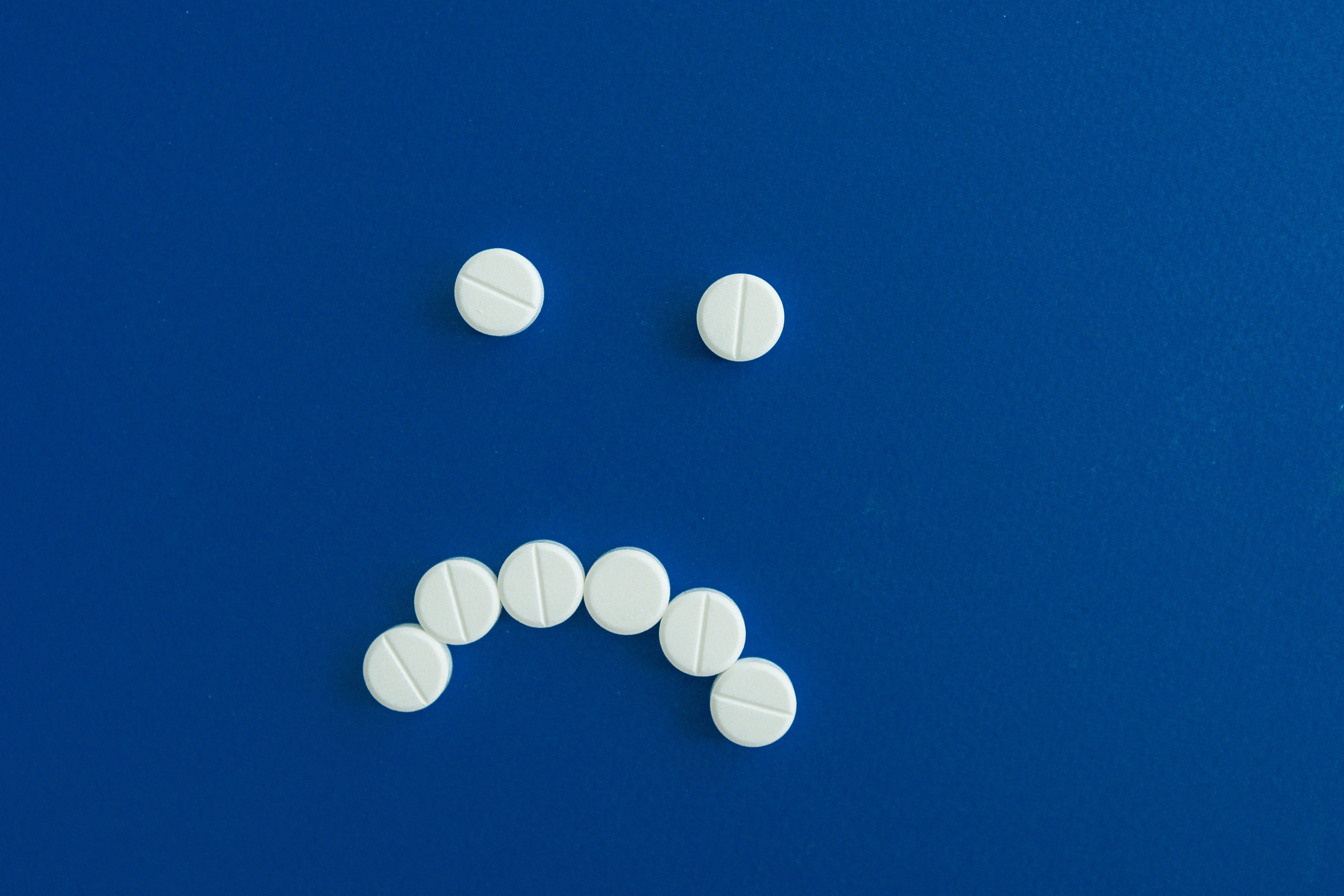 Sad smiley face made of pills