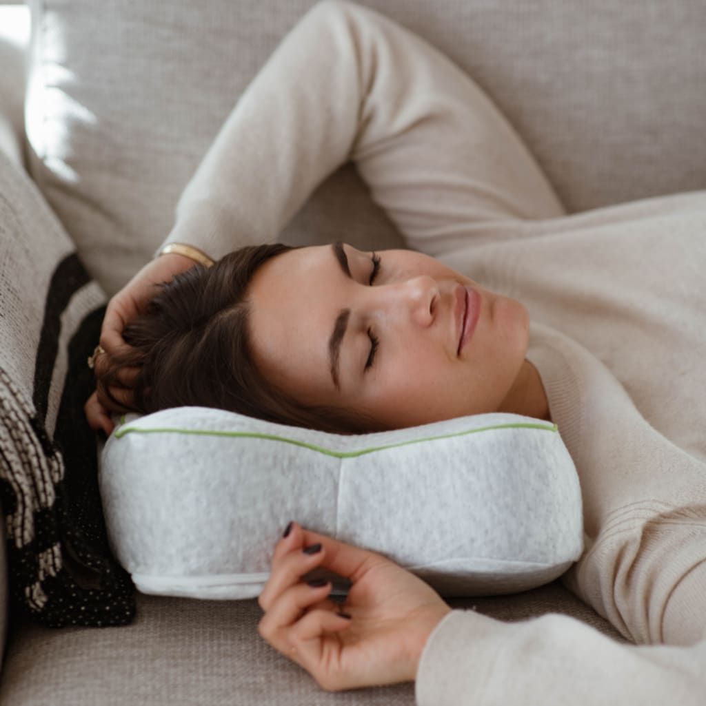 Woman relaxing on blackroll pillow