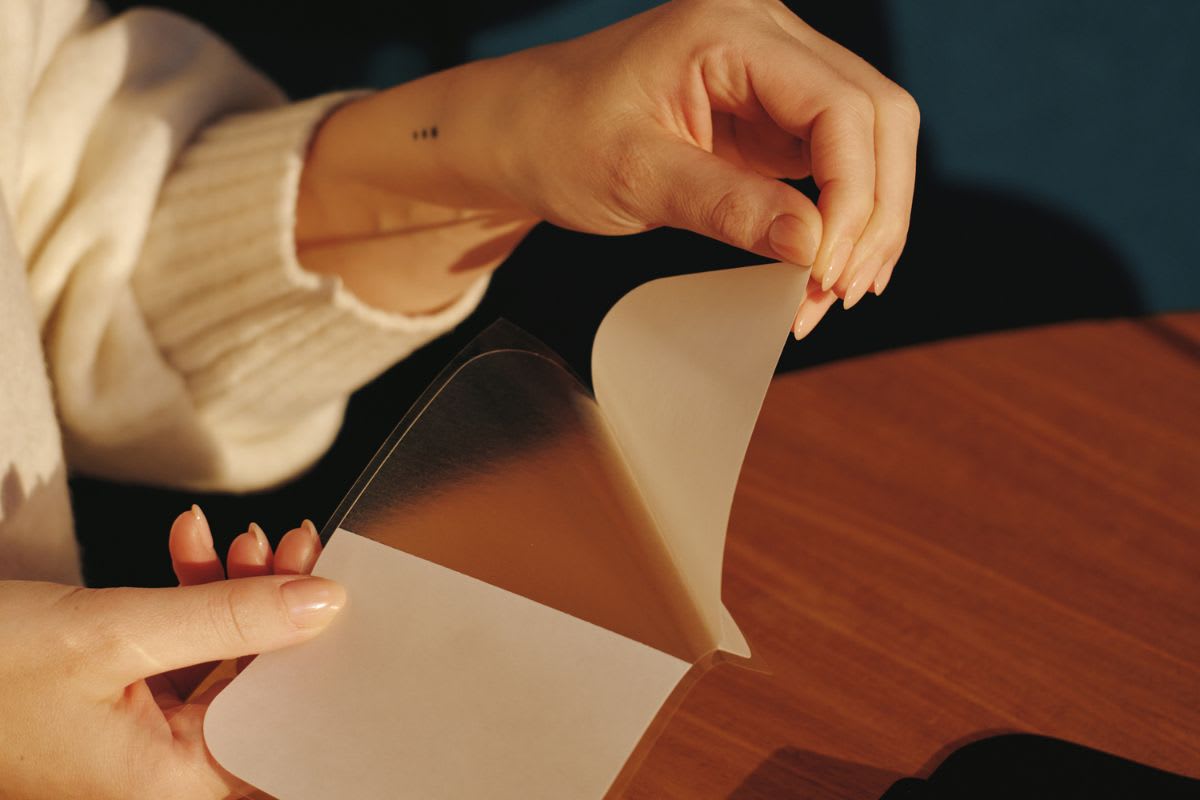 Adhesive foil being unfolded and prepared