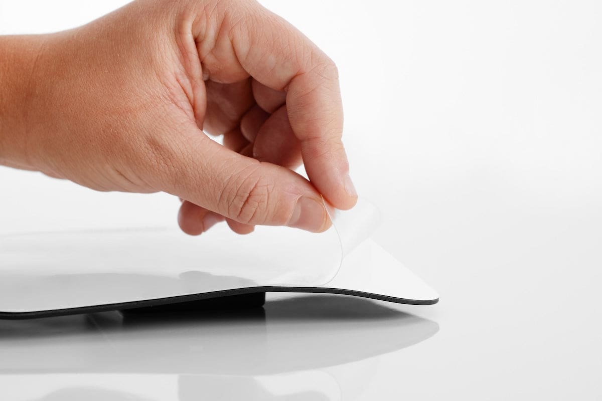 Adhesive foil being removed from the Thermo Pad by hand